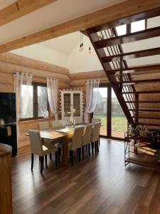 a dining room with a wooden table and chairs at Chata z Bala 