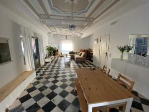 a living room with a table and a checkered floor at Zulla House in Nazaré