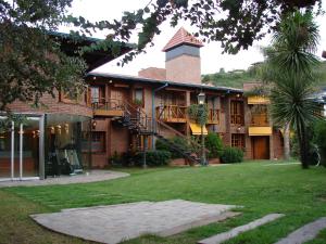 a large brick building with a spiral staircase on it at San Isidro in Villa Carlos Paz