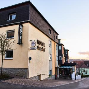 a hotel building with a sign that reads house hugging at Hotel Berghof in Baumholder