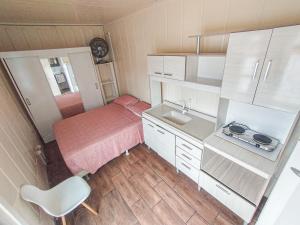 a small bedroom with a bed and a sink at Marco Zero Containers 4 in Balneário Camboriú