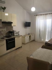 a kitchen with a stove and a microwave at Sea view apartment near the beach S2-Jelsa center in Jelsa