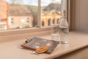 a couple of keys and a book on a window sill at The Black Bull Hotel in Kirkby Stephen
