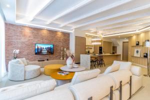 a living room with white furniture and a brick wall at Apartamento Seis Lunas PA in Marbella