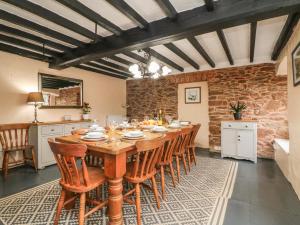 a dining room with a wooden table and chairs at Travellers Rest in Minehead