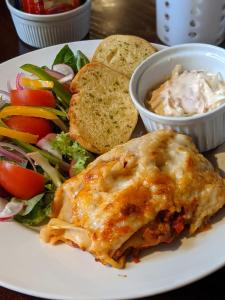 a plate of food with a sandwich and a salad at Linden Tree in Gloucester