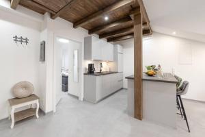 a kitchen with white cabinets and a counter top at Exklusive (DG) Neubau-Ferienwohnung mit Fernsicht in Konstanz +19 photos