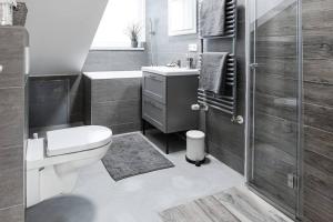 a bathroom with a toilet and a sink and a shower at Exklusive (DG) Neubau-Ferienwohnung mit Fernsicht in Konstanz