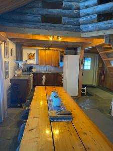 a large wooden table in a kitchen with a refrigerator at Liirakka Levi in Levi