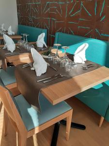 a table with chairs and a wooden table with a table cloth at DOMITYS BASALTIK in Agde