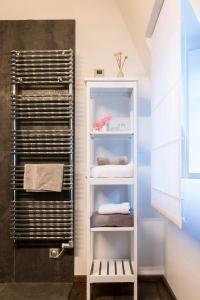 a towel rack in a bathroom with towels at La Maison Blanche in Beaune