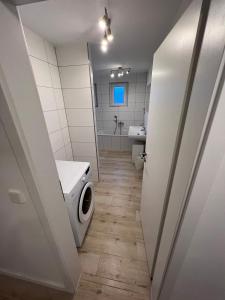 a bathroom with a washing machine and a sink at Monteurwohnung Pforzheim Zentrum in Pforzheim