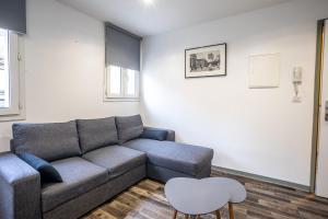 a living room with a couch and a chair at Le Saint Louis in Périgueux