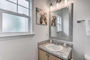 a bathroom with a sink and a mirror and a window at Idyllic Pensacola Home with Yard and Fire Pit! in Pensacola +20 photos