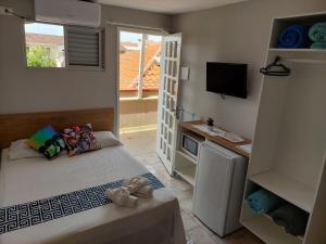 A bed or beds in a room at Pousada das Ondas Riviera