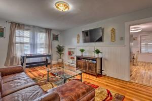 a living room with a couch and a pool table at Lovely Stoughton Getaway Near Train Station! in Stoughton