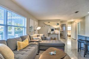 a living room with a couch and a table at Lush Seminole Surf Inn with Backyard Fire Pit! in Seminole