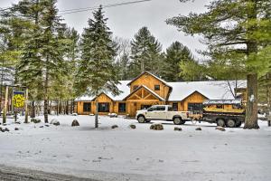 a truck parked in front of a log cabin in the snow at Adirondacks Cabin Fish, Hunt and Hike! in Glenfield