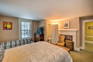a bedroom with a bed and a fireplace at Vintage Farmhouse Near Sunday River Ski Slopes! in Rumford