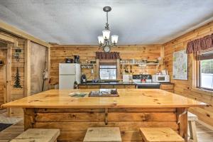 a large wooden kitchen with a large wooden table at Pet-Friendly Brantingham Cabin by ATV Trails in Glenfield