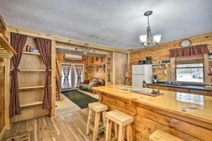 a kitchen with wooden walls and a counter with stools at Pet-Friendly Brantingham Cabin by ATV Trails in Glenfield