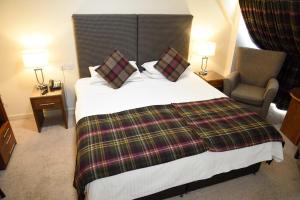 a hotel room with a bed and two nightstands at The Royal Hotel in Portree