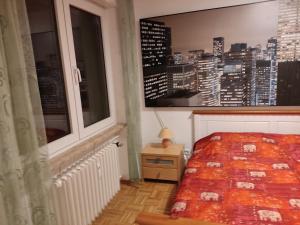a bedroom with a window with a view of a city at Lotus in Trier