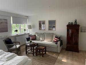 a living room with a couch and a table at Trouville Bed & Breakfast in Hornbæk