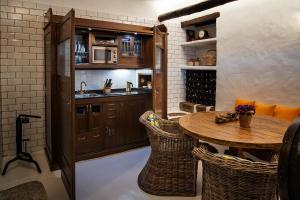 a kitchen with a wooden table and chairs at Las Pérgolas Villa Rural in Tías
