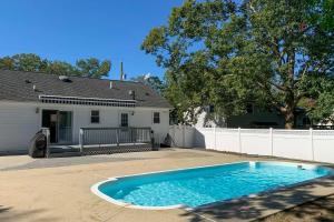 a swimming pool in the driveway of a house at Charming Somers Point House with Private Pool! in Somers Point