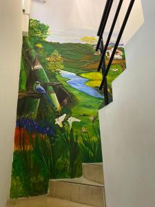 a mural of a river on the side of a staircase at Luxury Hostal in Manizales