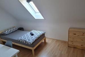 a small bedroom with a bed and a dresser at L8 Street - Pforzheim Nordstadt in Pforzheim