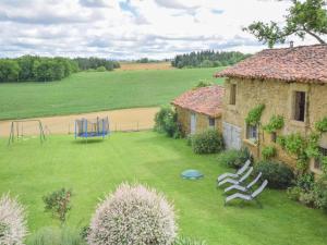 a yard with a house and a playground at Grande Gite Bassoues in Bassoues