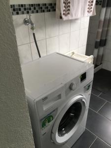 a washer and dryer in a corner of a bathroom at Haus Ursula 2 in Brake +2 photos