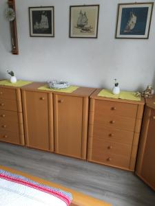 a room with four dressers and a wall at Haus Ursula 2 in Brake