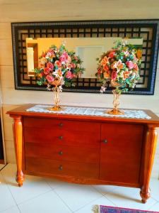 a dresser with two vases on it in front of a mirror at Hotel Pousada Irmaos Freyhardt in Rio de Janeiro