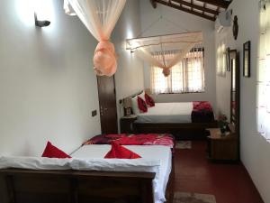 a room with two beds and a room with two windows at Villa Bubble Sea in Unawatuna