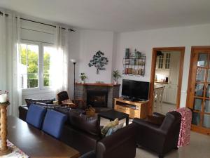 a living room with a couch and a fireplace at Sunny Holiday Home in Creixell