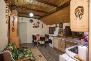 a kitchen with a table and a dining room at Apartmani SP Jovanovic in Crni Vrh