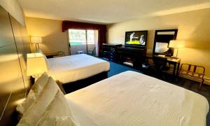 a hotel room with two beds and a flat screen tv at Indian Head Resort in Lincoln