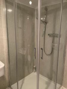 a shower with a glass door in a bathroom at Shandwick House in Tain +38 photos