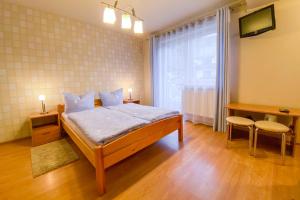 une chambre avec un lit et une grande fenêtre dans l'établissement Bar-Kawiarnia BASIA Pokoje Gościnne, à Szczyrk
