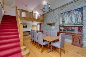 a dining room with a wooden table and chairs at Home Farm B&B - Poppy Room in Forfar