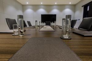a large conference room with a long table with chairs at D'avenue Boutique Hotel Accra in Accra +32 photos
