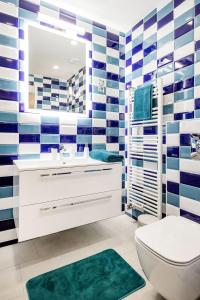 a bathroom with blue and white striped walls at Centre point Apartment in Budapest +40 photos