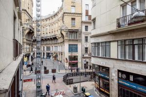 a city street with buildings and people walking on the street at Centre point Apartment in Budapest