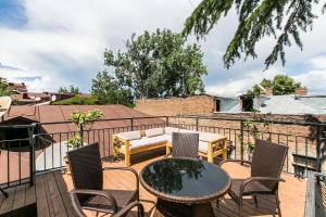 a patio with a table and chairs on a balcony at Georgian Guest House on Asatiani in Tbilisi City