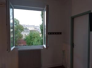 a bathroom with a large window and a radiator at Le Girond'Inn in Libourne