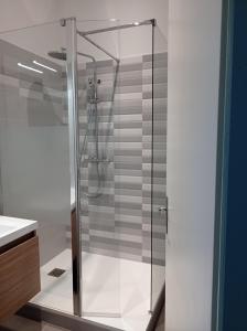 a shower with a glass door in a bathroom at Le Girond'Inn in Libourne