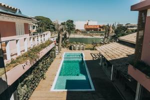 a swimming pool on a balcony of a building at Pousada Dora in Florianópolis